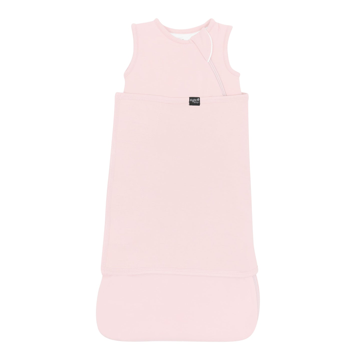 Sleep Bag Swaddler in Blush 1.0 shown swaddled with the Black Kyte Baby logo visible