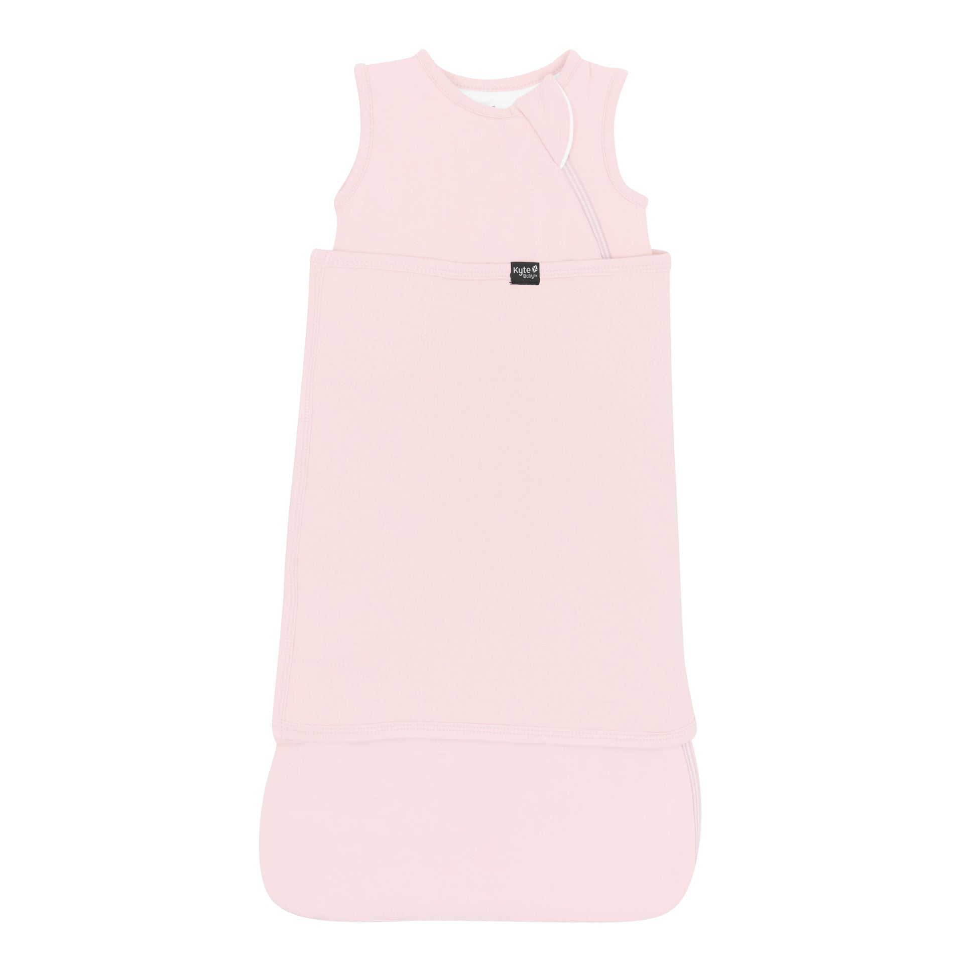 Sleep Bag Swaddler in Blush 1.0 shown swaddled with the Black Kyte Baby logo visible