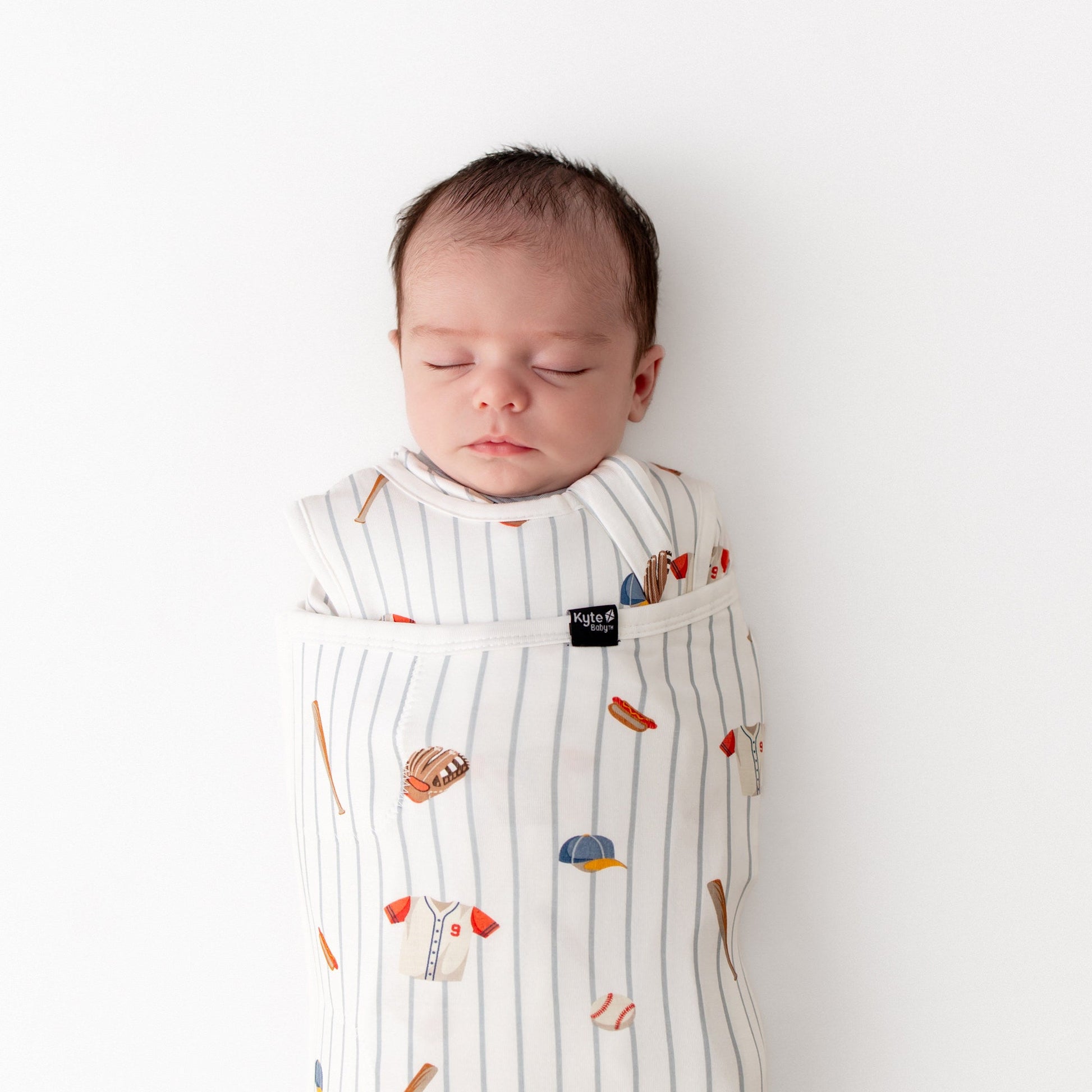 Close up of sleeping newborn swaddled in the the Sleep Bag Swaddler in Home Run 1.0