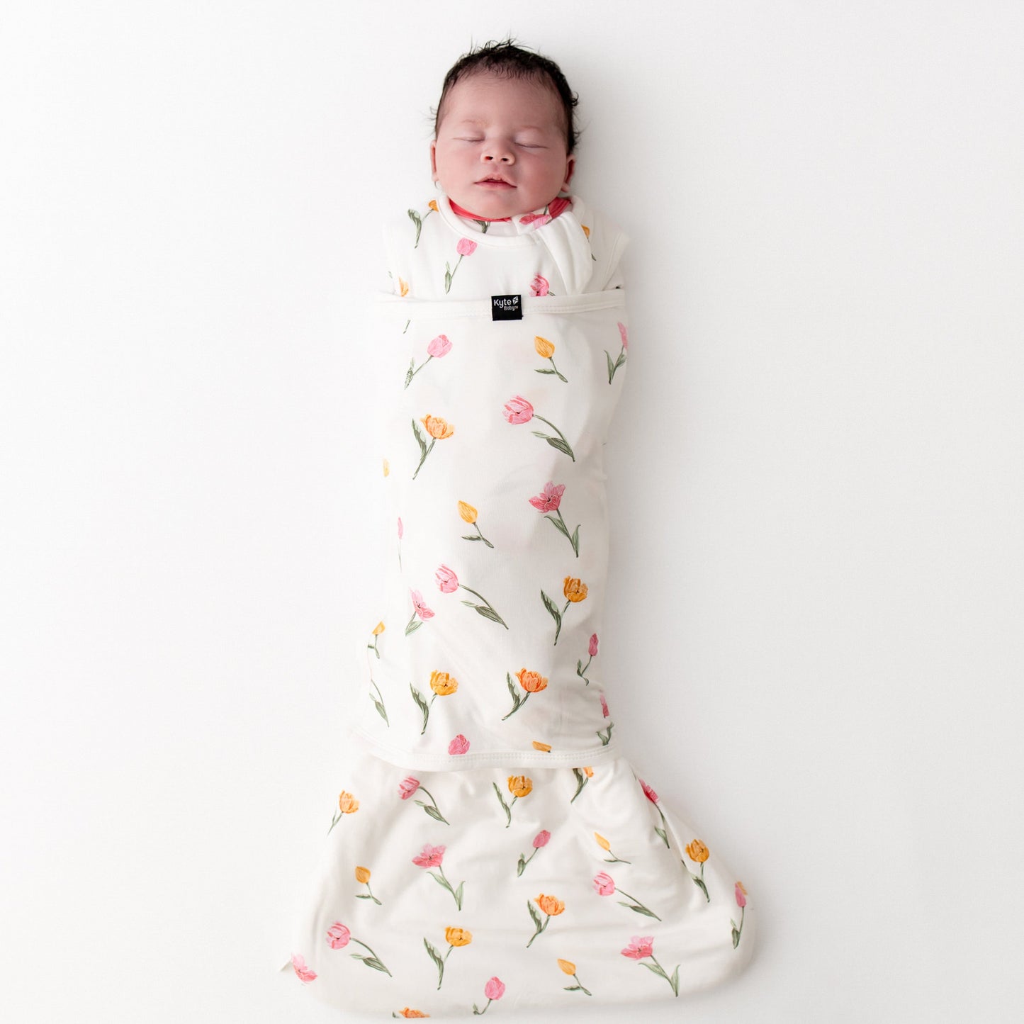 sleeping newborn swaddled in the Sleep Bag Swaddler in Tulip 1.0