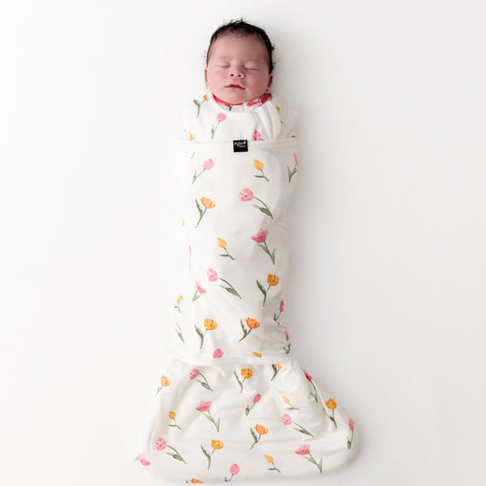 sleeping newborn swaddled in the Sleep Bag Swaddler in Tulip 1.0